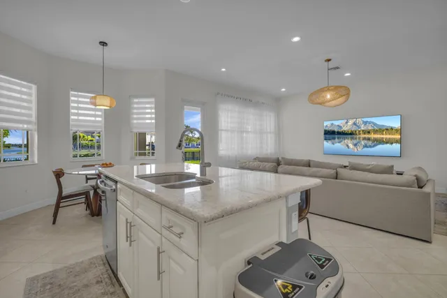 a spacious bedroom with a large bed and painting on the wall