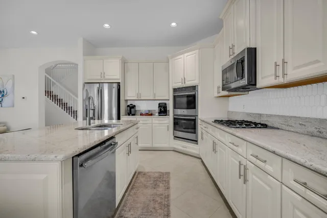a spacious bathroom with a tub sink and mirror