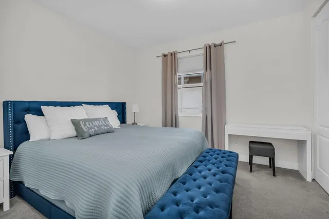 a view of a city with lots of residential buildings and ocean view in back