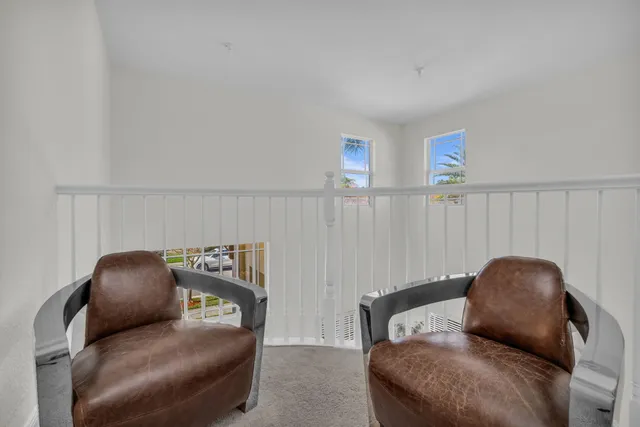 an aerial view of a city with lots of residential buildings ocean and mountain view in back