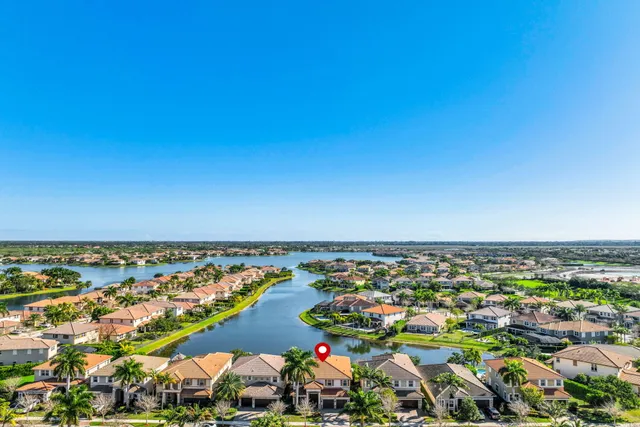 a front view of a house with a yard and potted plants