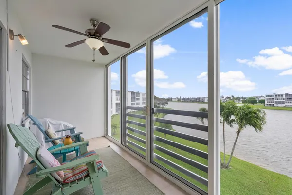 a living room with a floor to ceiling window and a table