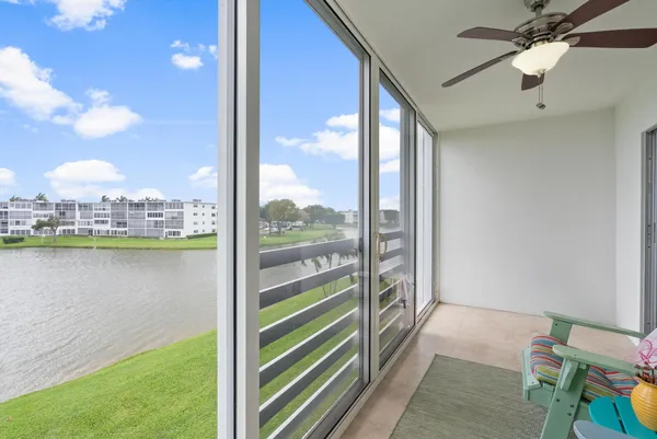 a view of a balcony with lake view and a floor to ceiling window