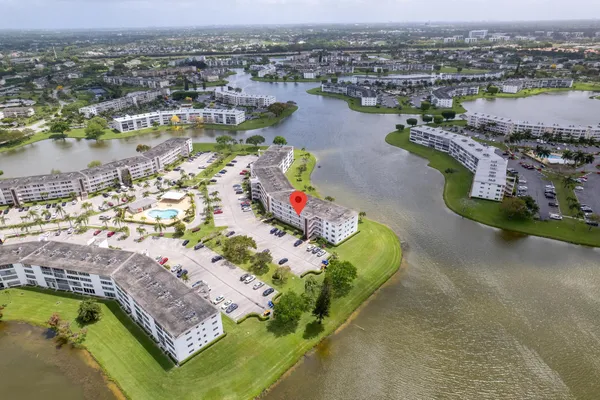 an aerial view of lake residential houses with outdoor space and ocean view