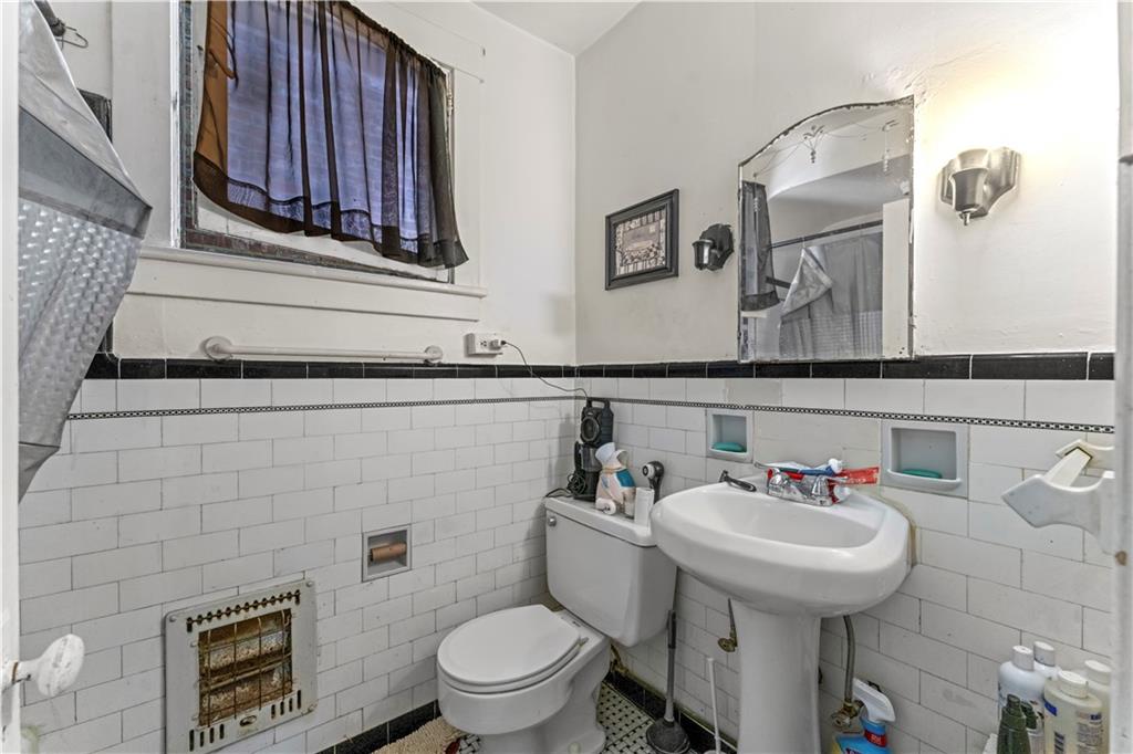 107 Ella Street McKees Rocks, PA 15136 - Photo 19 of 39 a bathroom with a sink a toilet and mirror