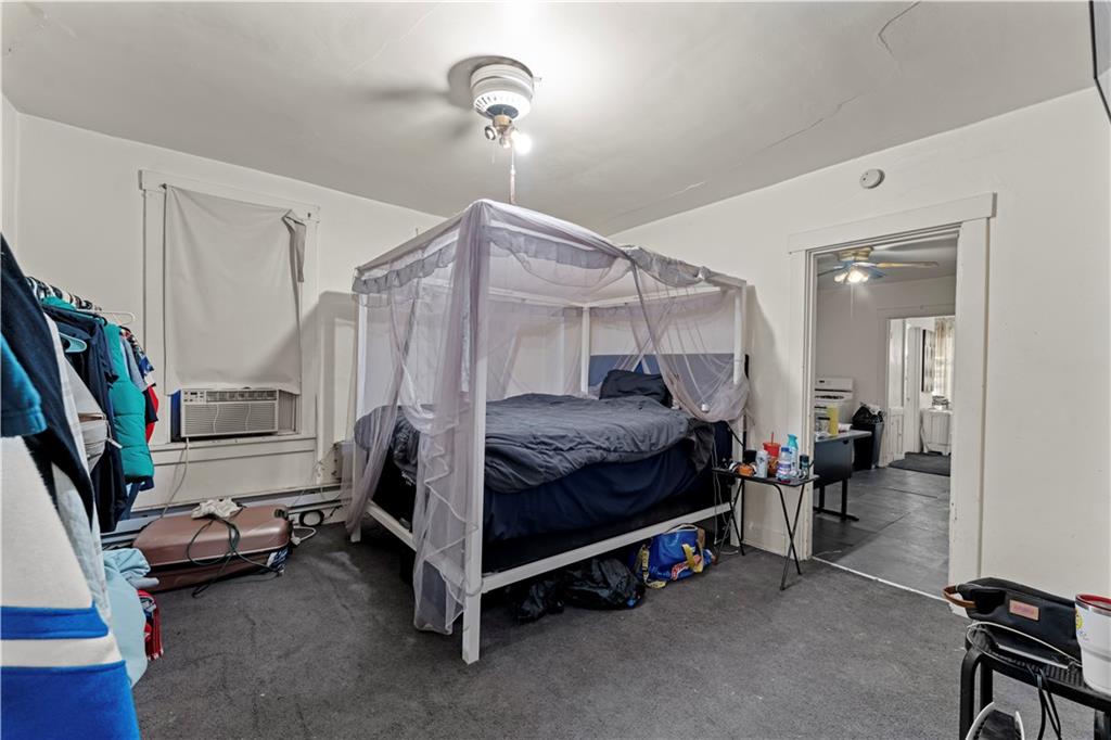 107 Ella Street McKees Rocks, PA 15136 - Photo 23 of 39 a bedroom with bed and a chandelier