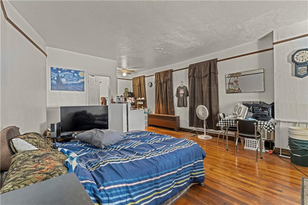 107 Ella Street McKees Rocks, PA 15136 - Photo 4 of 39 a bedroom with a bed a table and chair