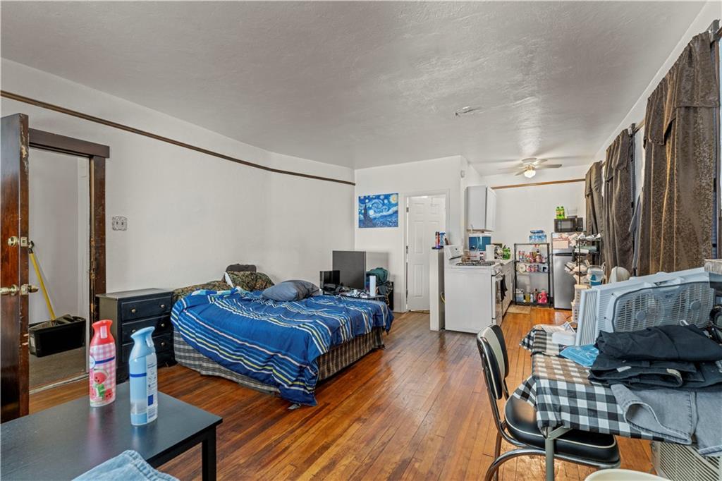 107 Ella Street McKees Rocks, PA 15136 - Photo 5 of 39 a bedroom with furniture and a chair