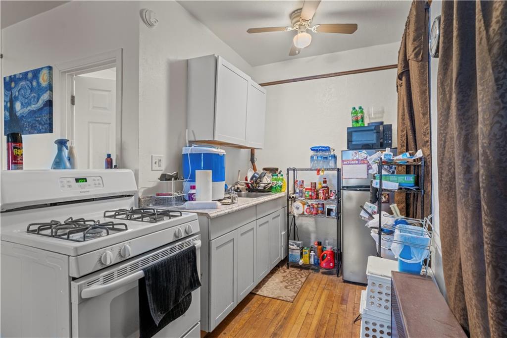 107 Ella Street McKees Rocks, PA 15136 - Photo 6 of 39 a kitchen with a stove and wooden floor