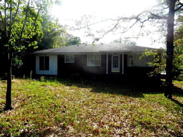 a view of house with backyard and garden