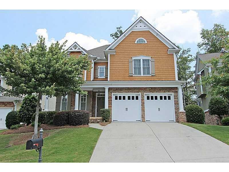 10546 Brookdale Road Alpharetta, GA 30022 - Photo 1 of 1 a front view of a house with a garden and plants