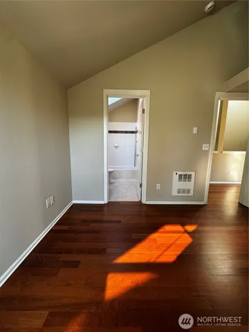 a view of an empty room and wooden floor