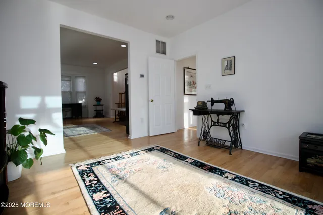 a living room with furniture a flat screen tv and a floor to ceiling window