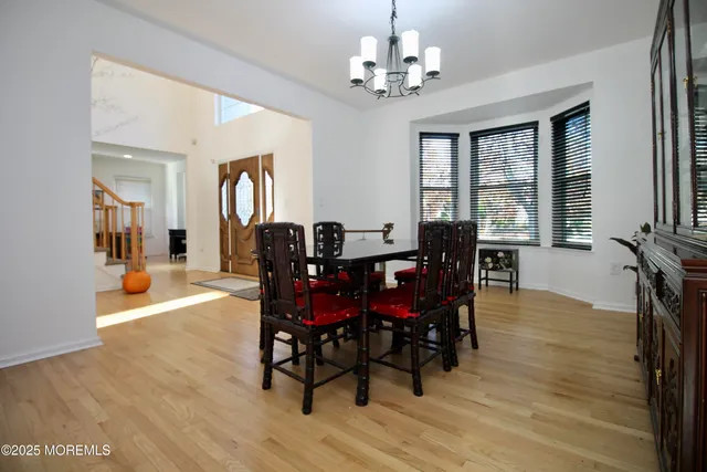 a kitchen with a table chairs refrigerator and microwave