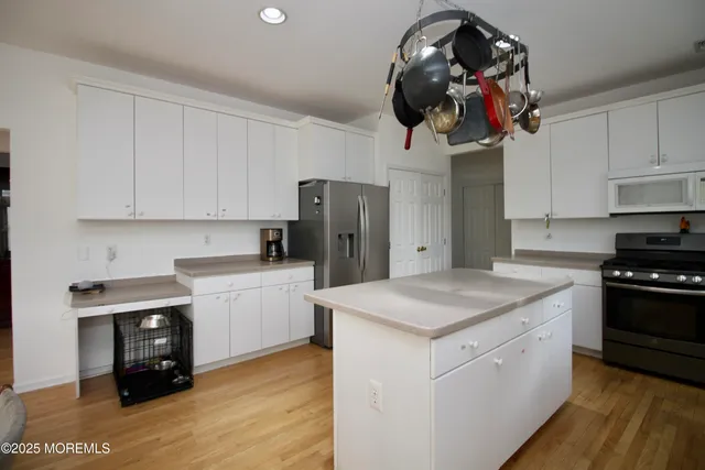 a view of a room with a table and chairs
