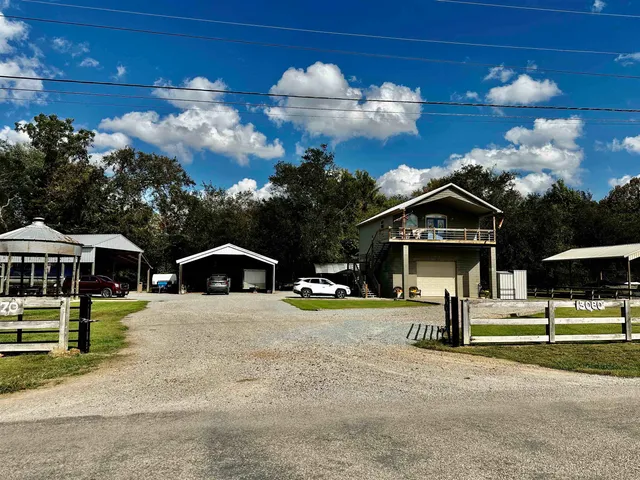 a view of house with yard in front of it