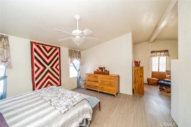a bedroom with bed and a chandelier