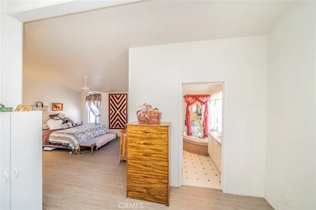 a bedroom with furniture and a wooden floor