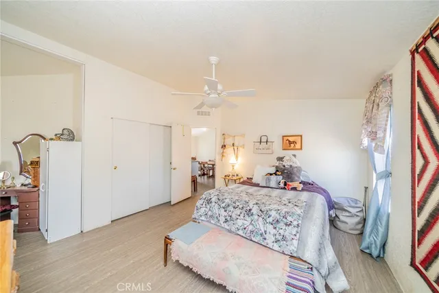 a bedroom with a large bed and a chandelier