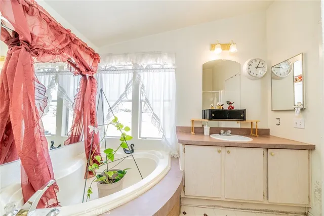 a bathroom with a sink a mirror and a bathtub