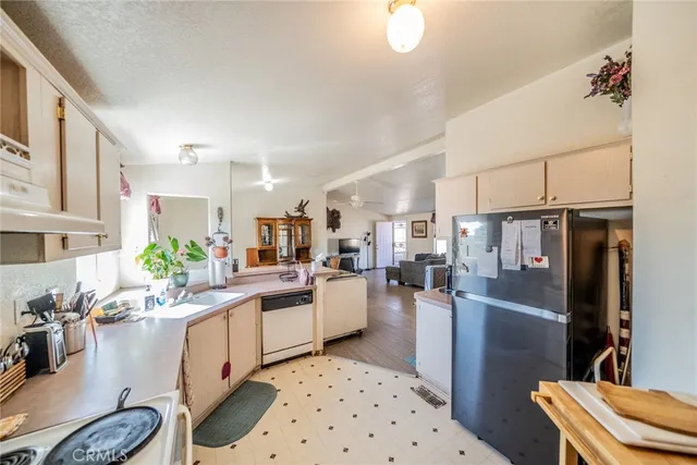 a kitchen with a sink appliances and cabinets