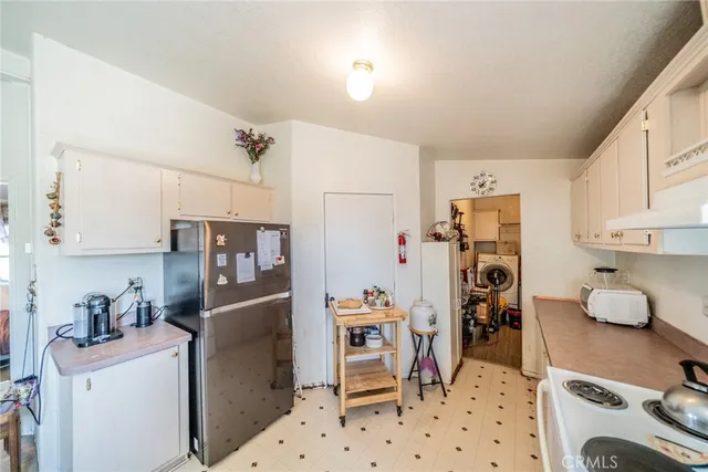 a kitchen with stainless steel appliances a refrigerator sink and cabinets