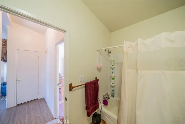 a bathroom with a shower and a glass door