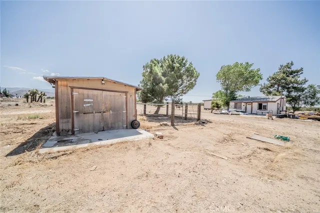a view of a yard with a house and snow on the road