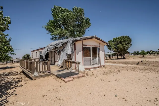 a view of a house with wooden floor in front of it