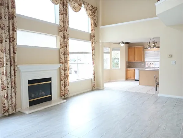 a view of a livingroom with a fireplace and window