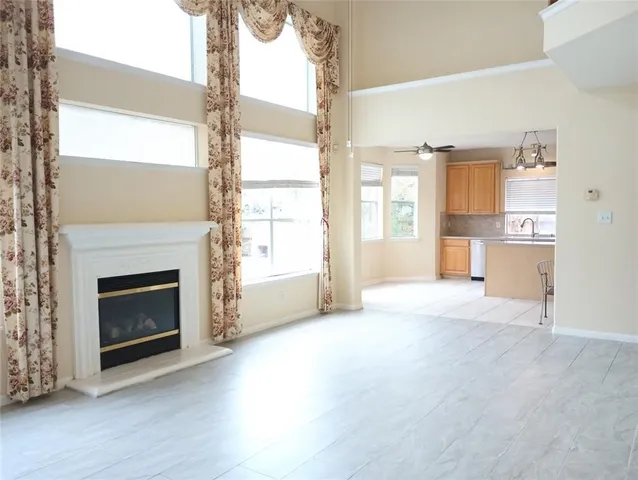 a view of a livingroom with a fireplace and window