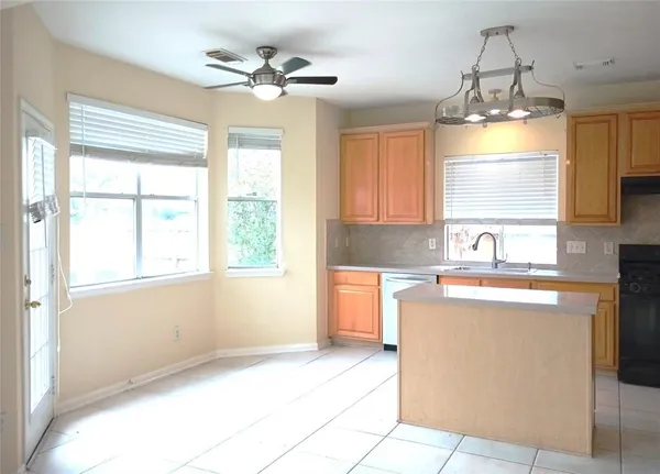 a kitchen with a window a sink and a cabinets