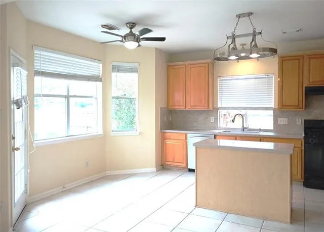a kitchen with a window a sink and a cabinets