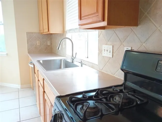 a kitchen with a stove and a sink