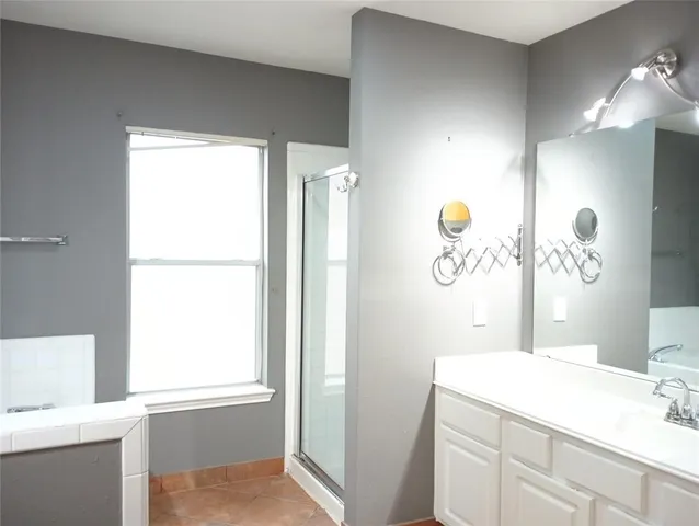 a bathroom with a bathtub a sink and a mirror