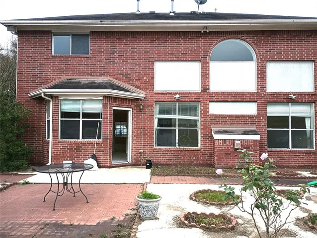 a front view of a house with outdoor seating