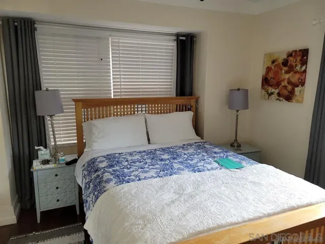 a bedroom with a large bed and a dresser