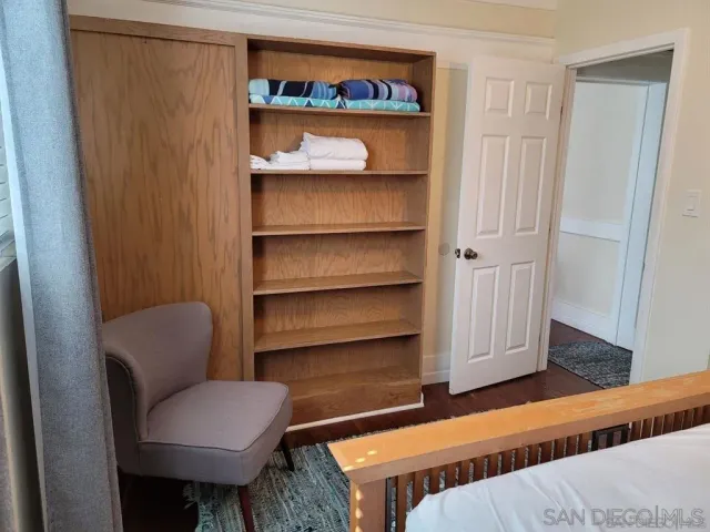 a living room with a furniture and a chair