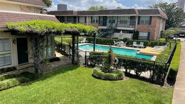 a view of a house with backyard and sitting area
