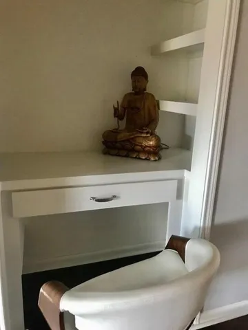 a living room with a furniture and a fireplace