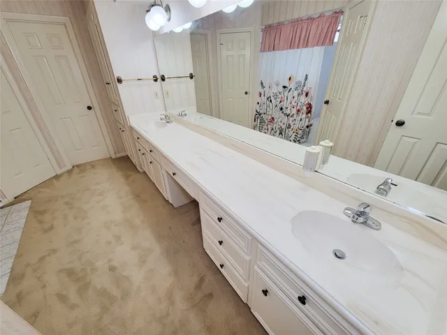 a bathroom with a double vanity sink and a mirror