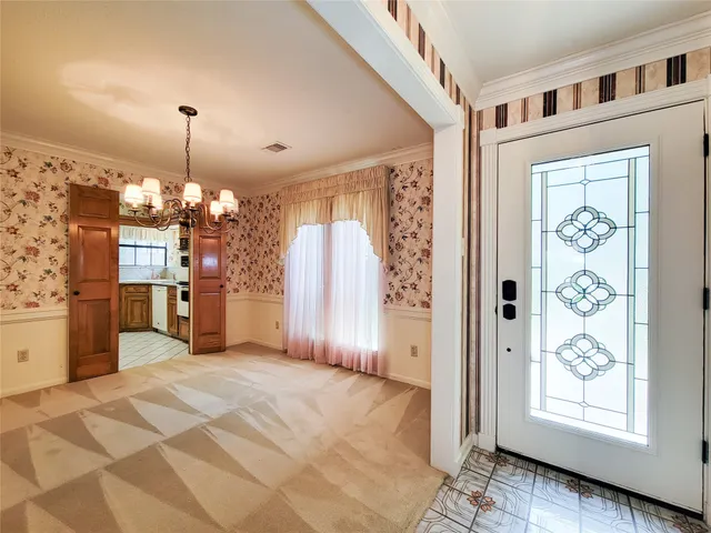 a view of a kitchen with a window and refrigerator