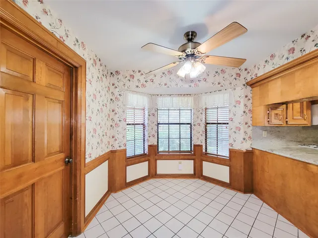 a view of an empty room with a fireplace and a large window