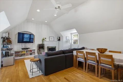 a living room with furniture a flat screen tv and kitchen view