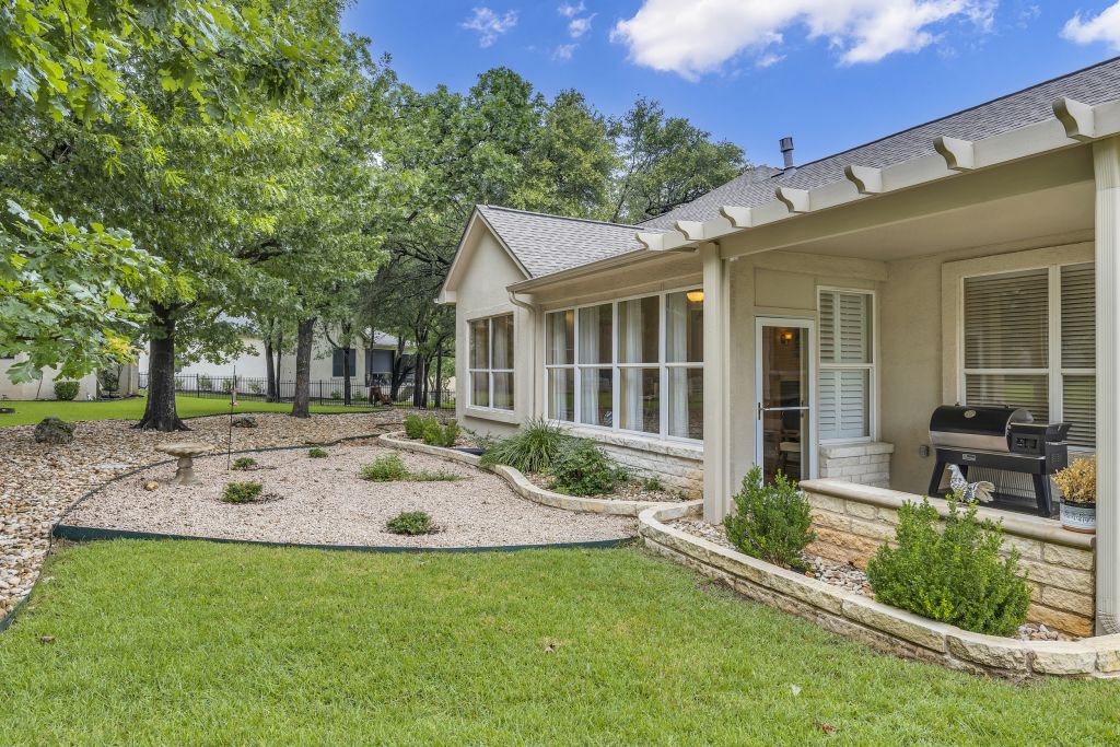 144 Cattle Trail Way Georgetown, TX 78633 - Photo 25 of 37 A private yard with mature trees offers a serene setting for outdoor living.