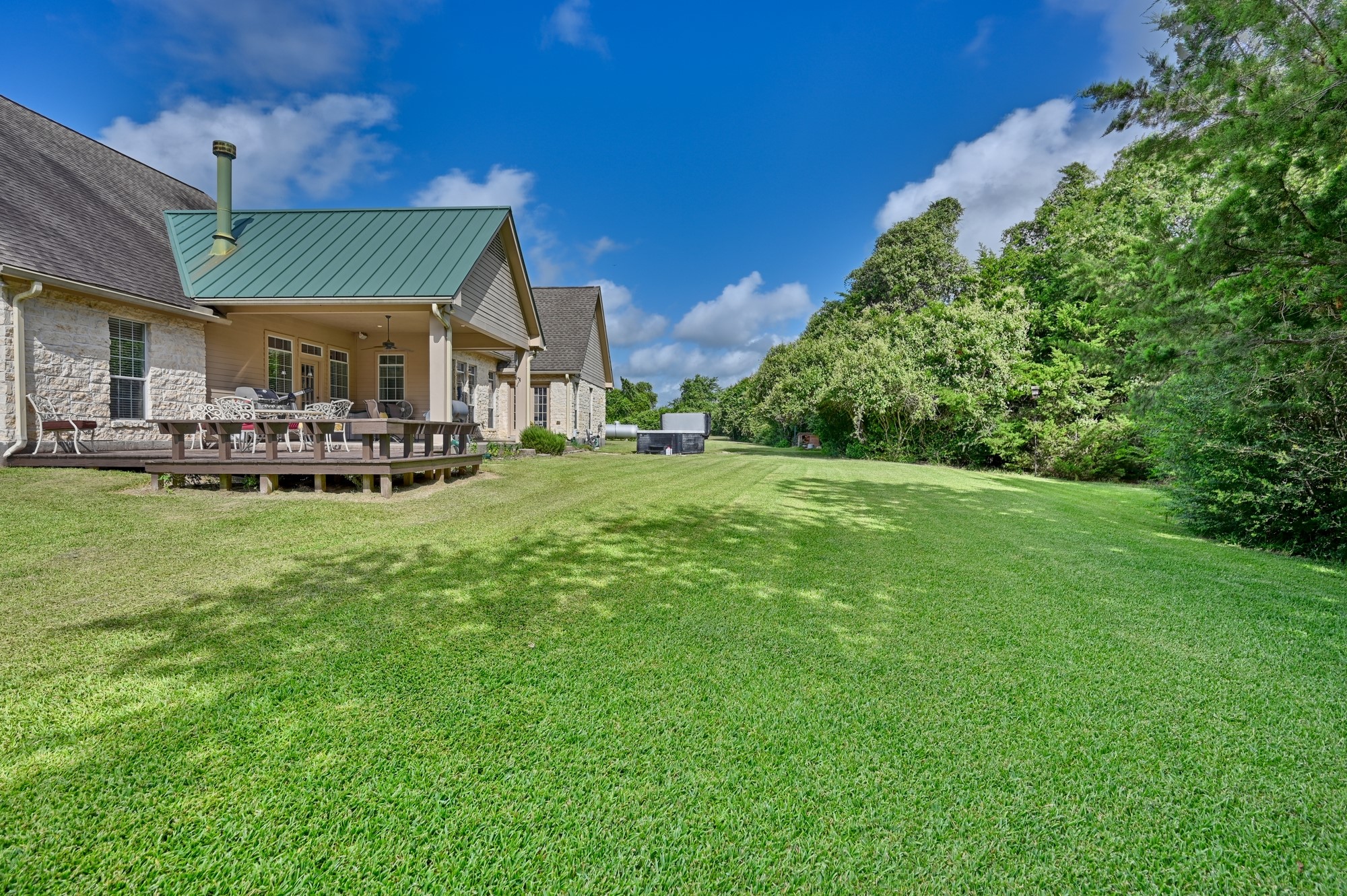 1205 Pecan Glen Road Brenham, TX 77833 - Photo 19 of 40 The back porch faces the wooded part of the property for privacy