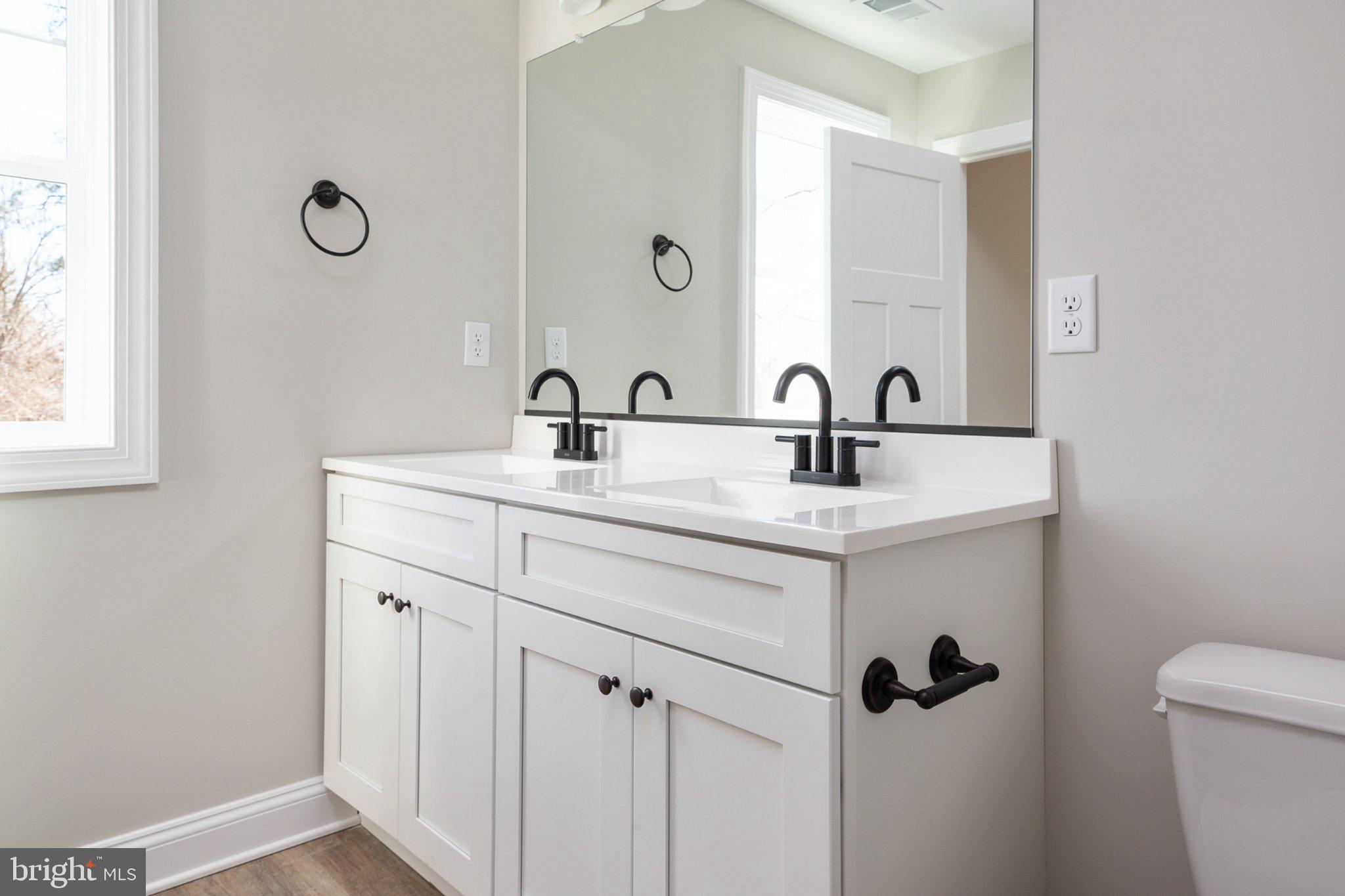 309 Talbot Road Stevensville, MD 21666 - Photo 23 of 26 Sleek dual vanity in modern bathroom.