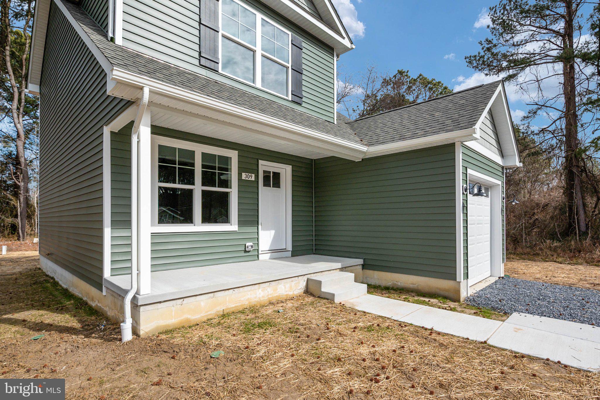 309 Talbot Road Stevensville, MD 21666 - Photo 4 of 26 Charming green home with inviting porch.