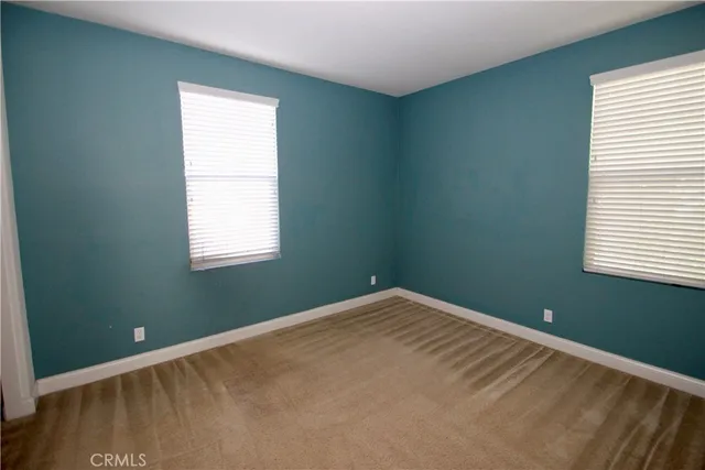 a view of a room with wooden floor and windows