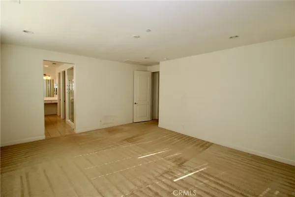 a spacious bathroom with a bathtub sink and mirror